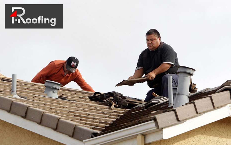 Damaged shingles repair on a residential roof for summer readiness