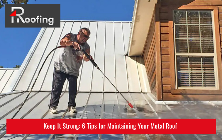 Technician cleaning metal roof during maintenance