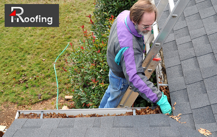 Roof technician performing routine maintenance on a roof